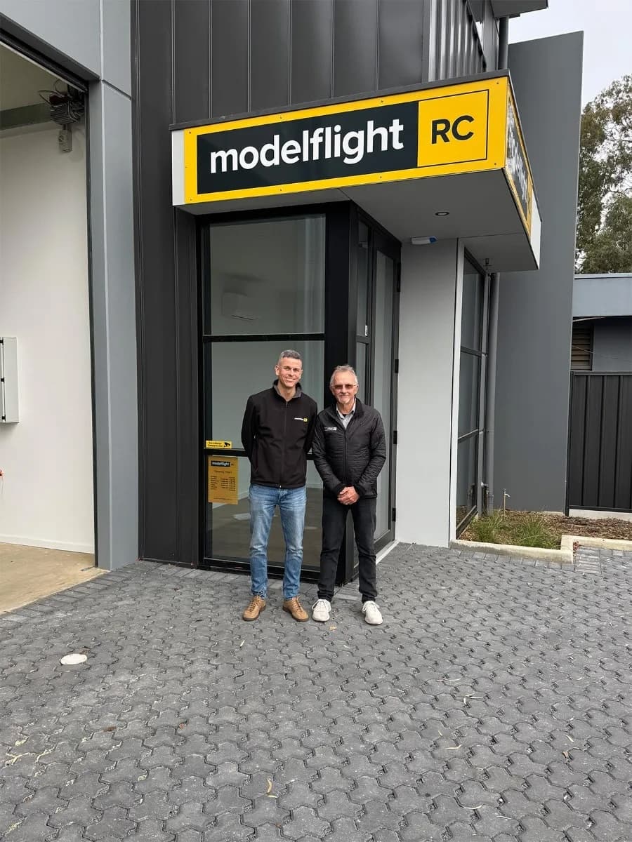 Three small plants being held by hands